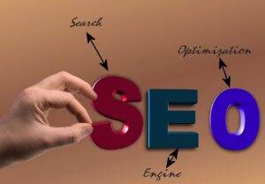 Hand holding SEO letters with arrows pointing to search engine optimization